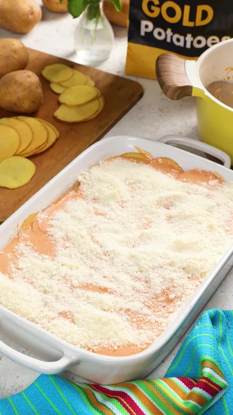 The dish covered edge to edge in grated Parmesan over the orange sauce.